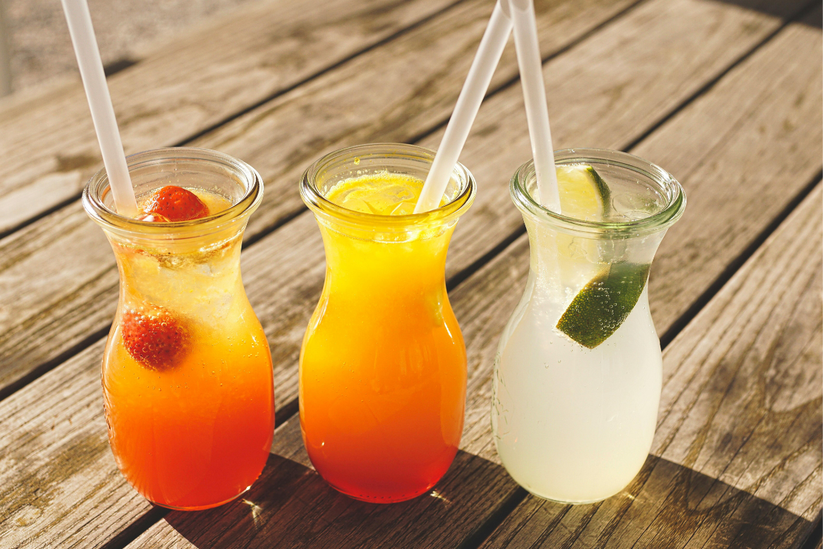 plastic straws in drinking glasses filled will juice