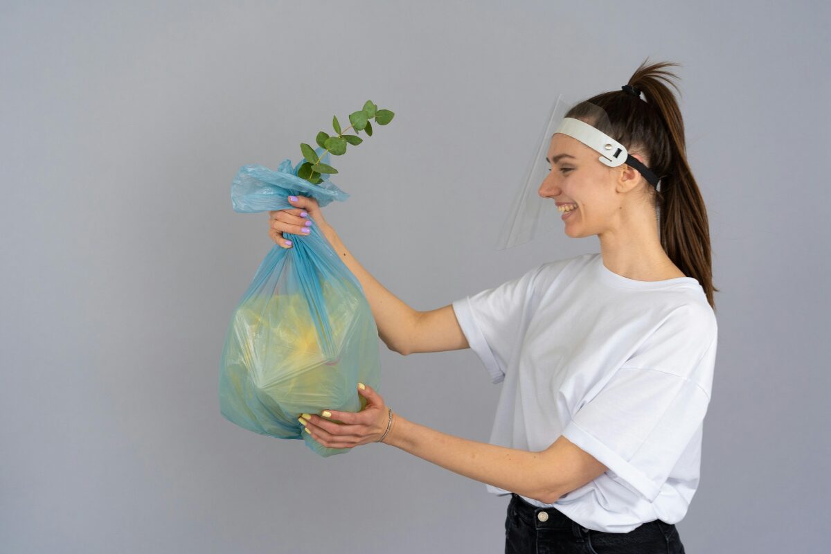 Garbage (1) A plastic garbage bag with a plant coming out of it