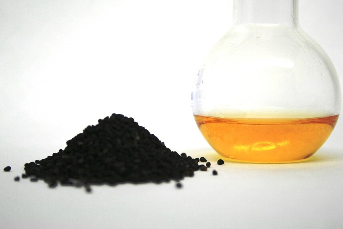 Solid plastic in a pile next to a jar of liquid.